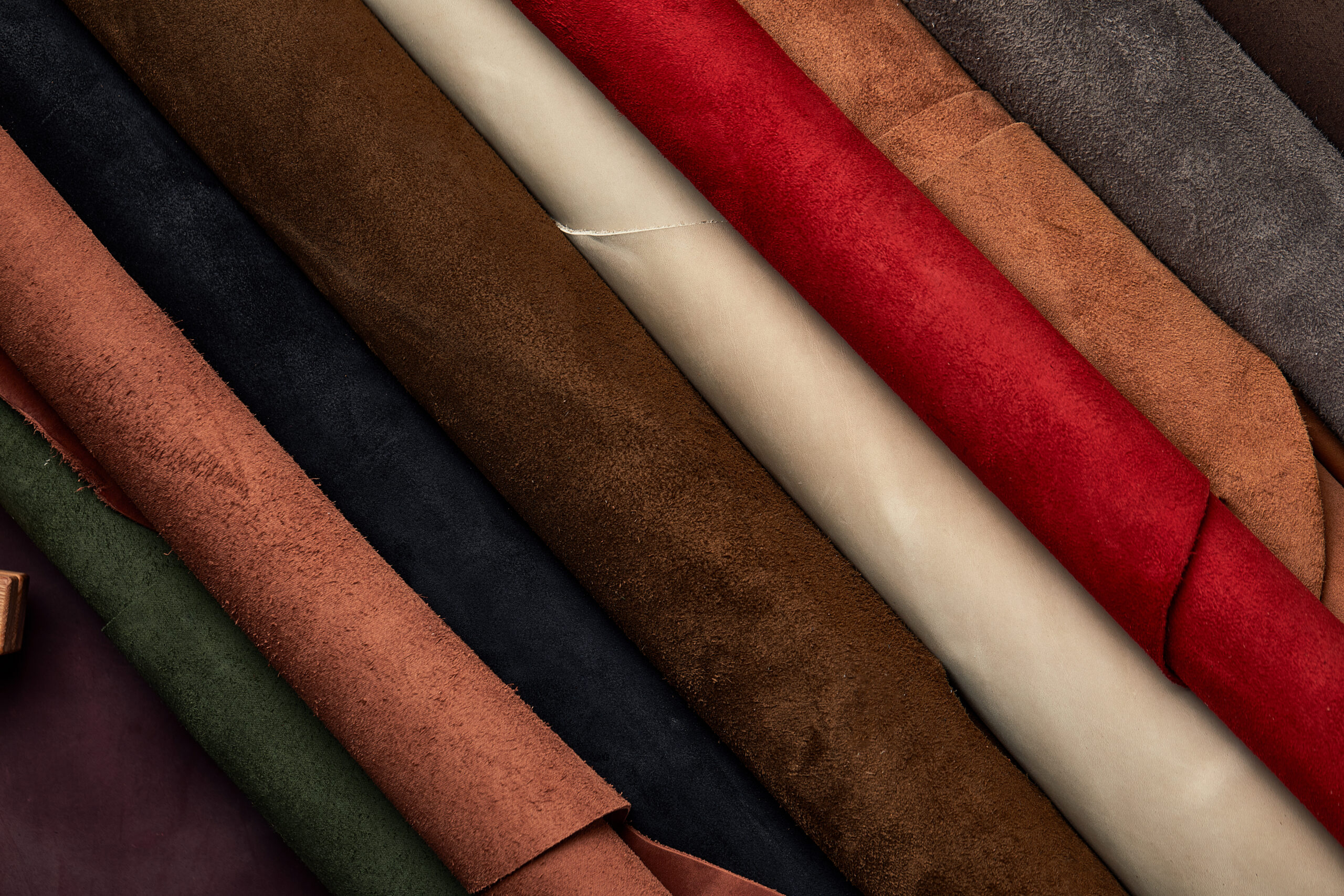 Artificial leather samples on a cow leather background. Top view.